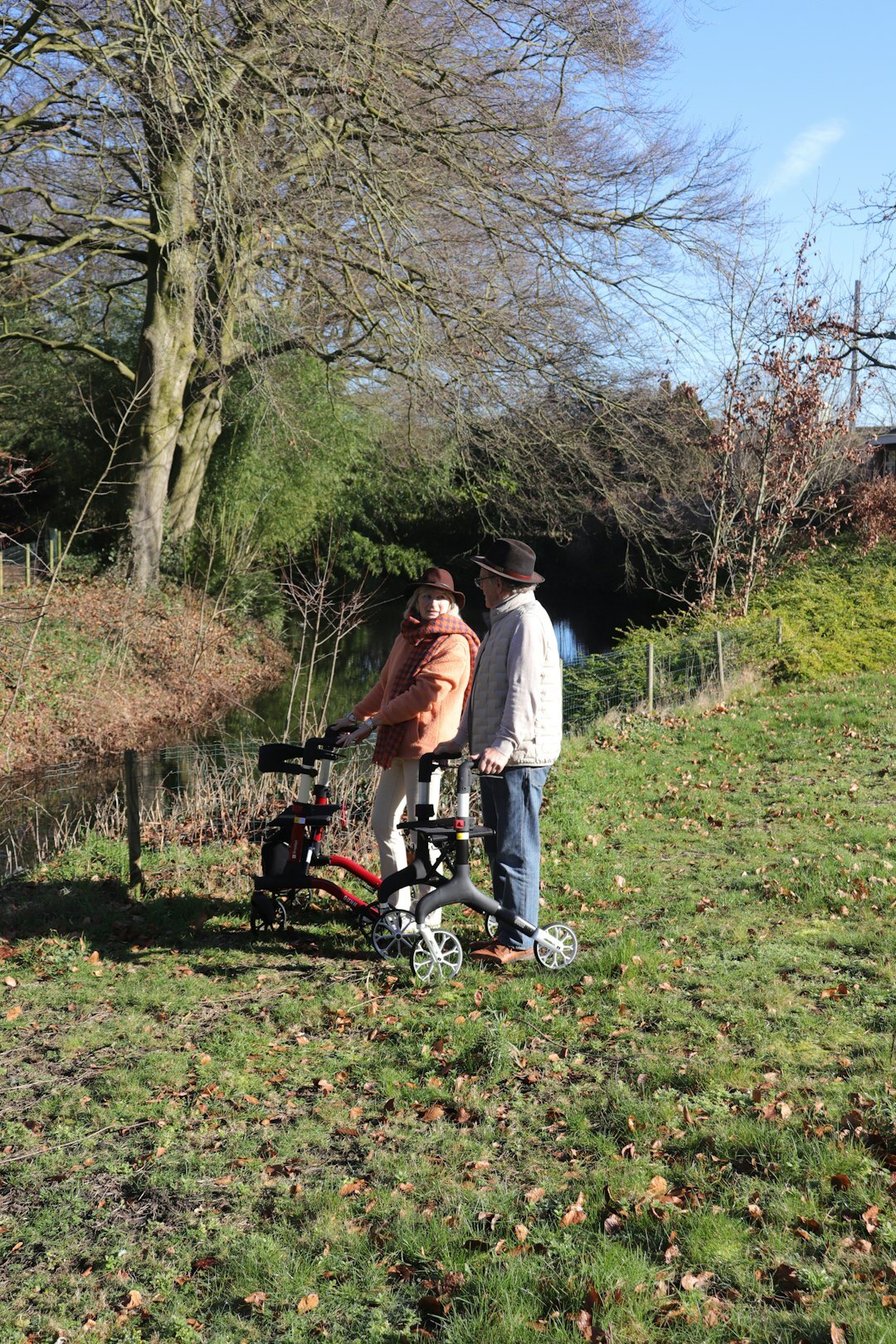 elderly couple walking in park