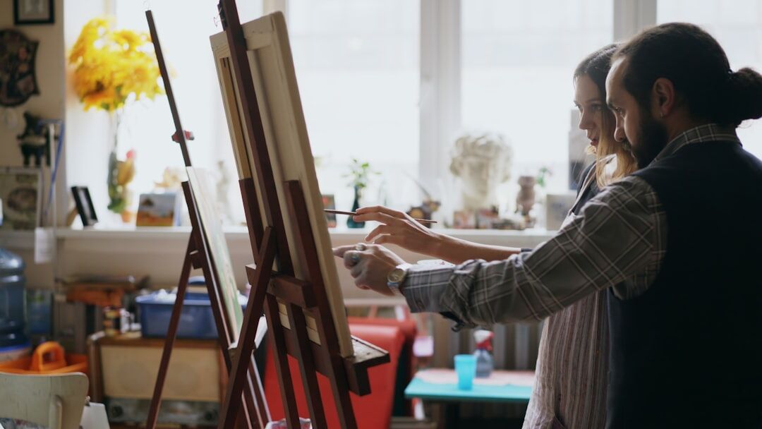 Seniors painting together in an art workshop